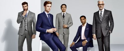 5 men wearing a variety of suits ranging from different shades of blue to different shades of grey