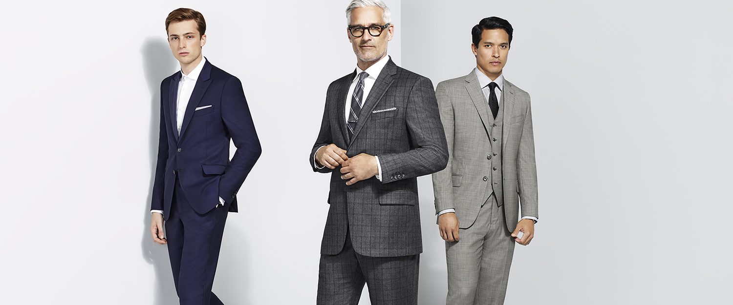 three men wearing different suits