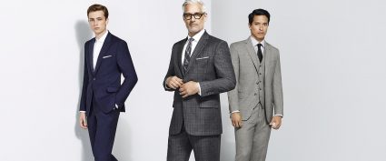 three men wearing different suits