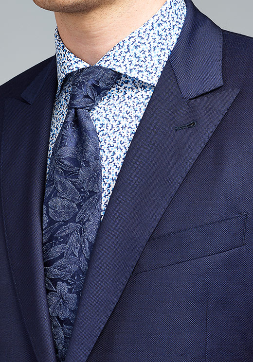 paisley shirt with blue floral tie and navy blue suit